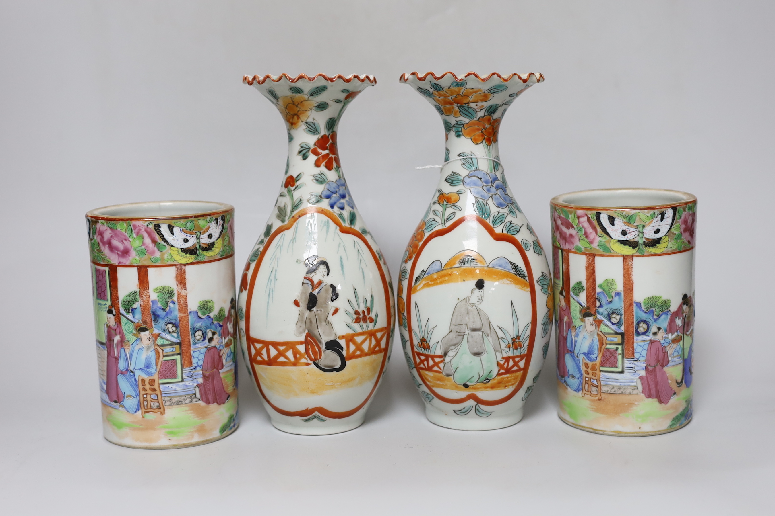 A pair of 19th century Cantonese famille rose porcelain brushpots, decorated with figural scenes, together with a further pair of Japanese export vases (4)